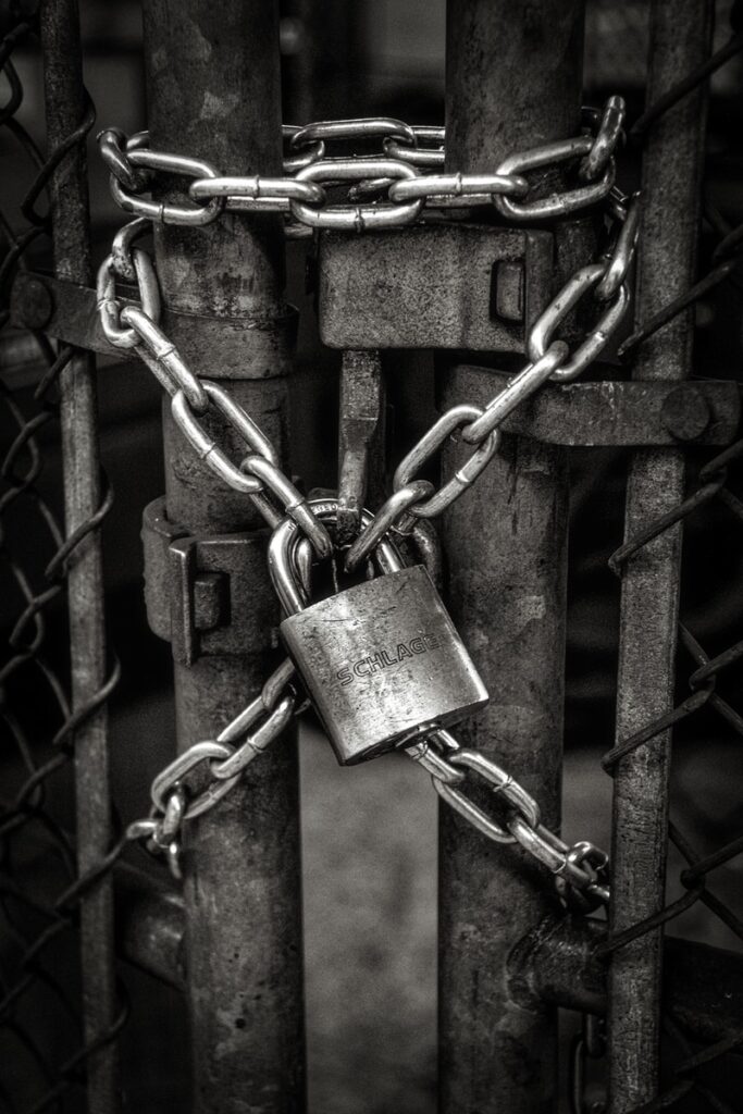 NFT - gray steel chain locked on gate